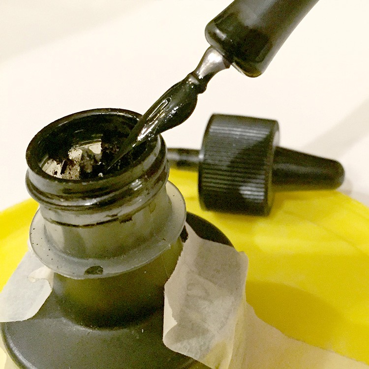 The bottle shown here, is designed so you can dip your pen all the way to the bottom without submerging the handle. Tap the nib against the bottle to remove some excess ink.